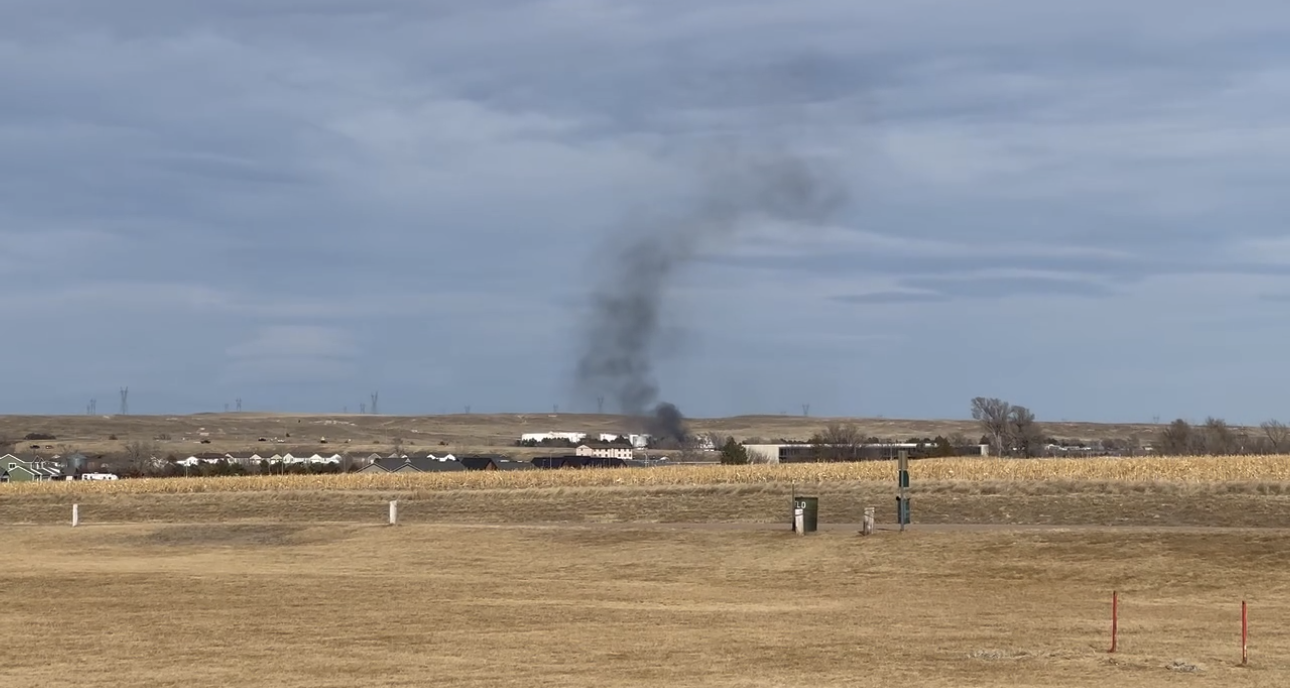 Grass fire ignites tool shed